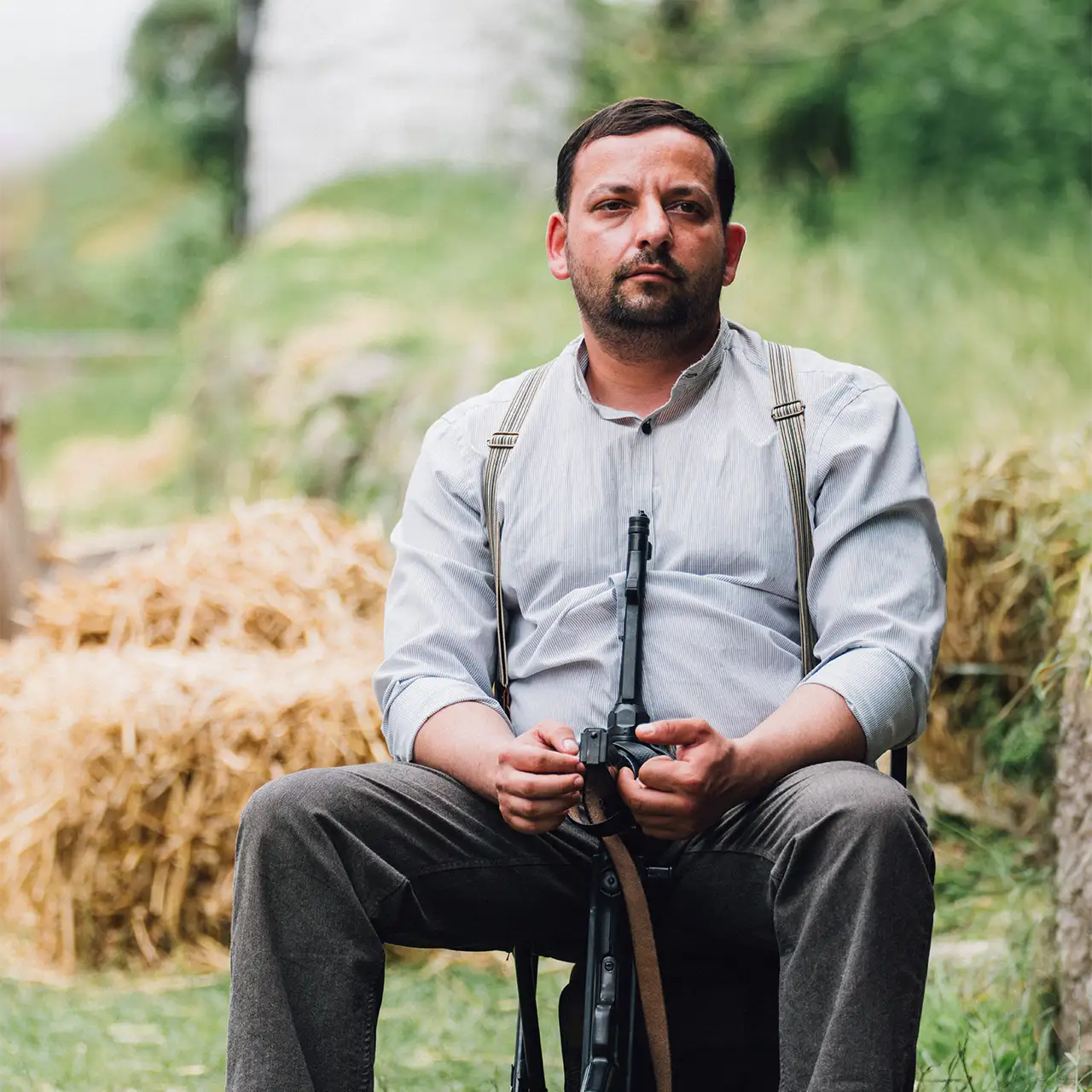 unknown actor holding a rifle