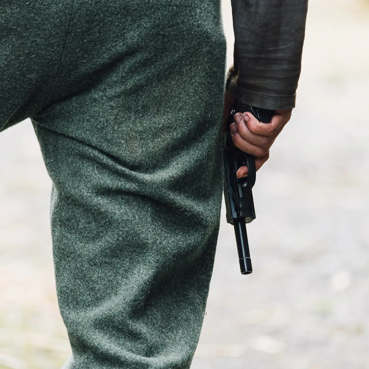 actor Kealan McAllister holding a pistol
